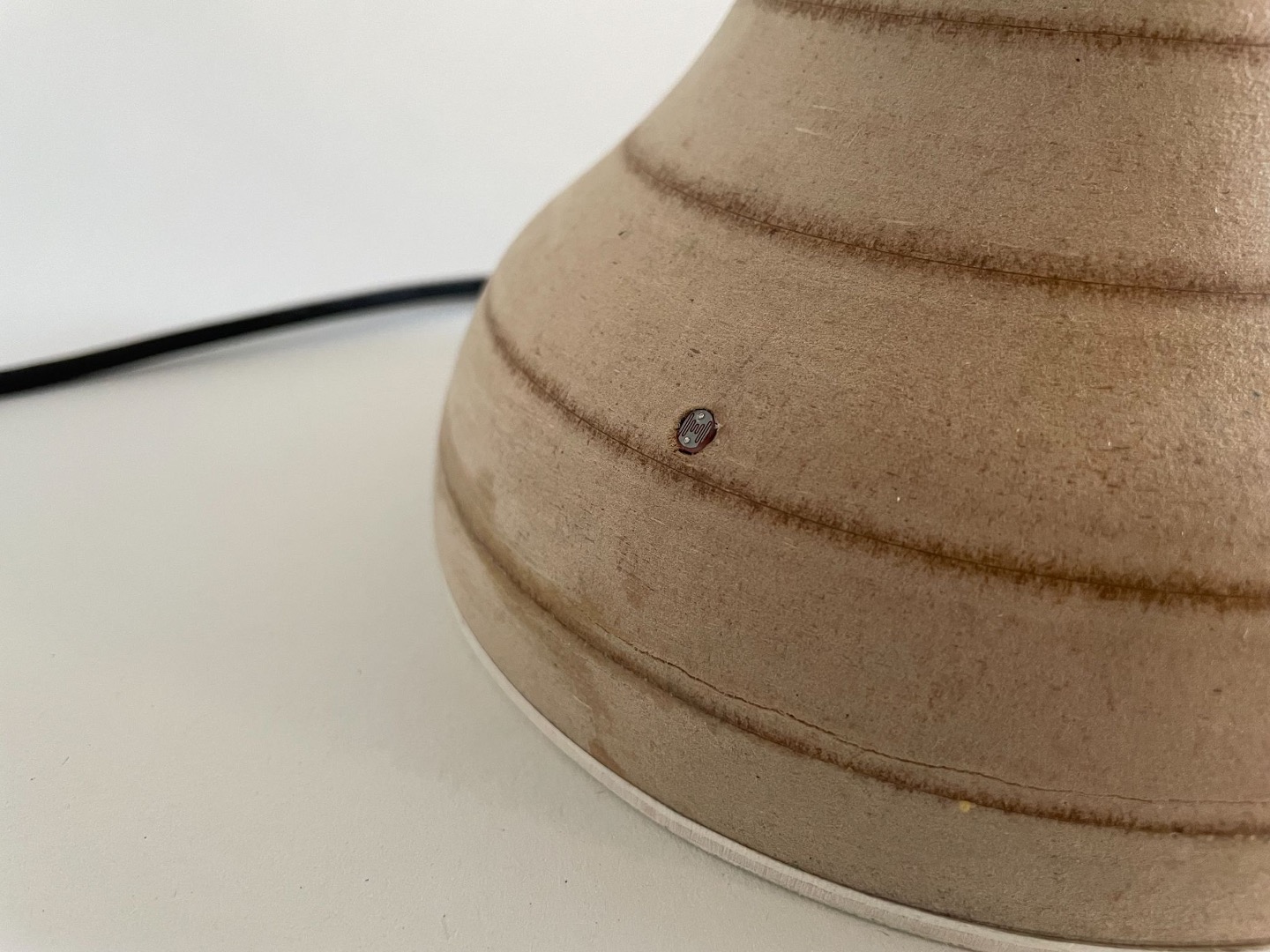 Detail of the LDR light sensor embedded flush in the wooden base