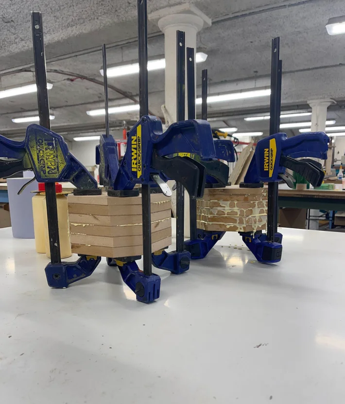 MDF blocks glued together and clamped overnight, then mounted on the lathe for woodturning