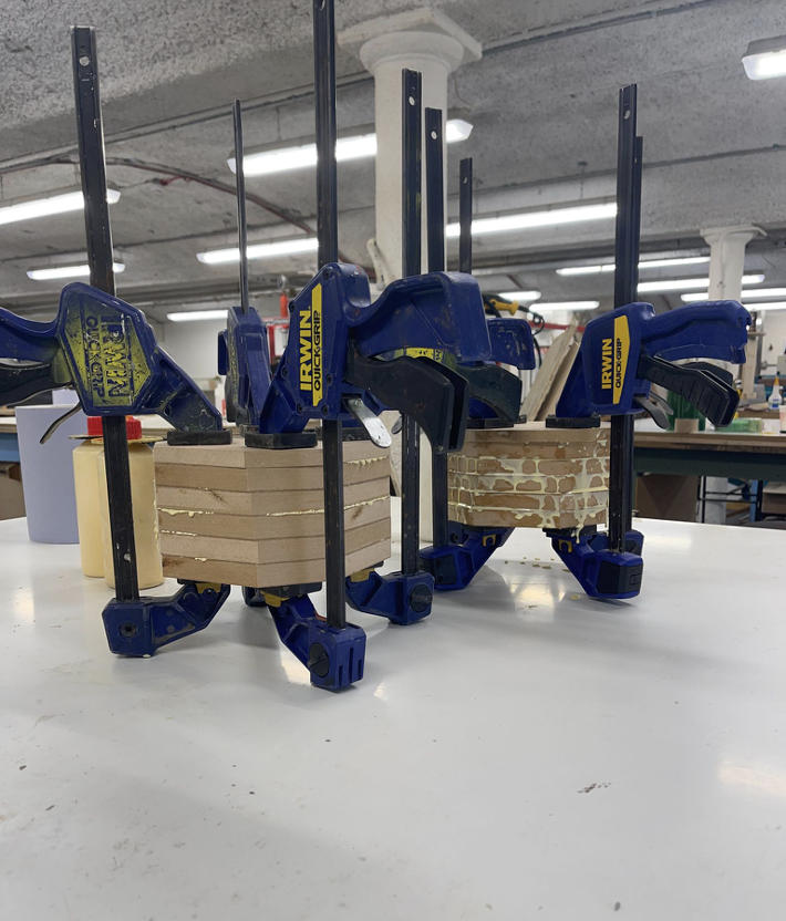 MDF blocks glued together and clamped overnight, then mounted on the lathe for woodturning