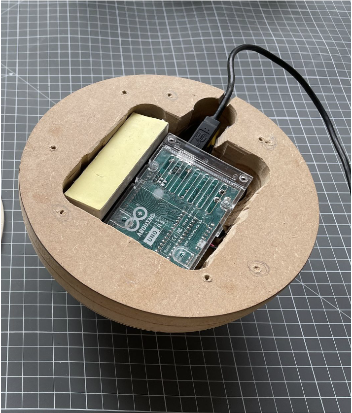 The wooden base hollowed out with a drill and chisel, electronics fitted inside, glass diffuser seated on top