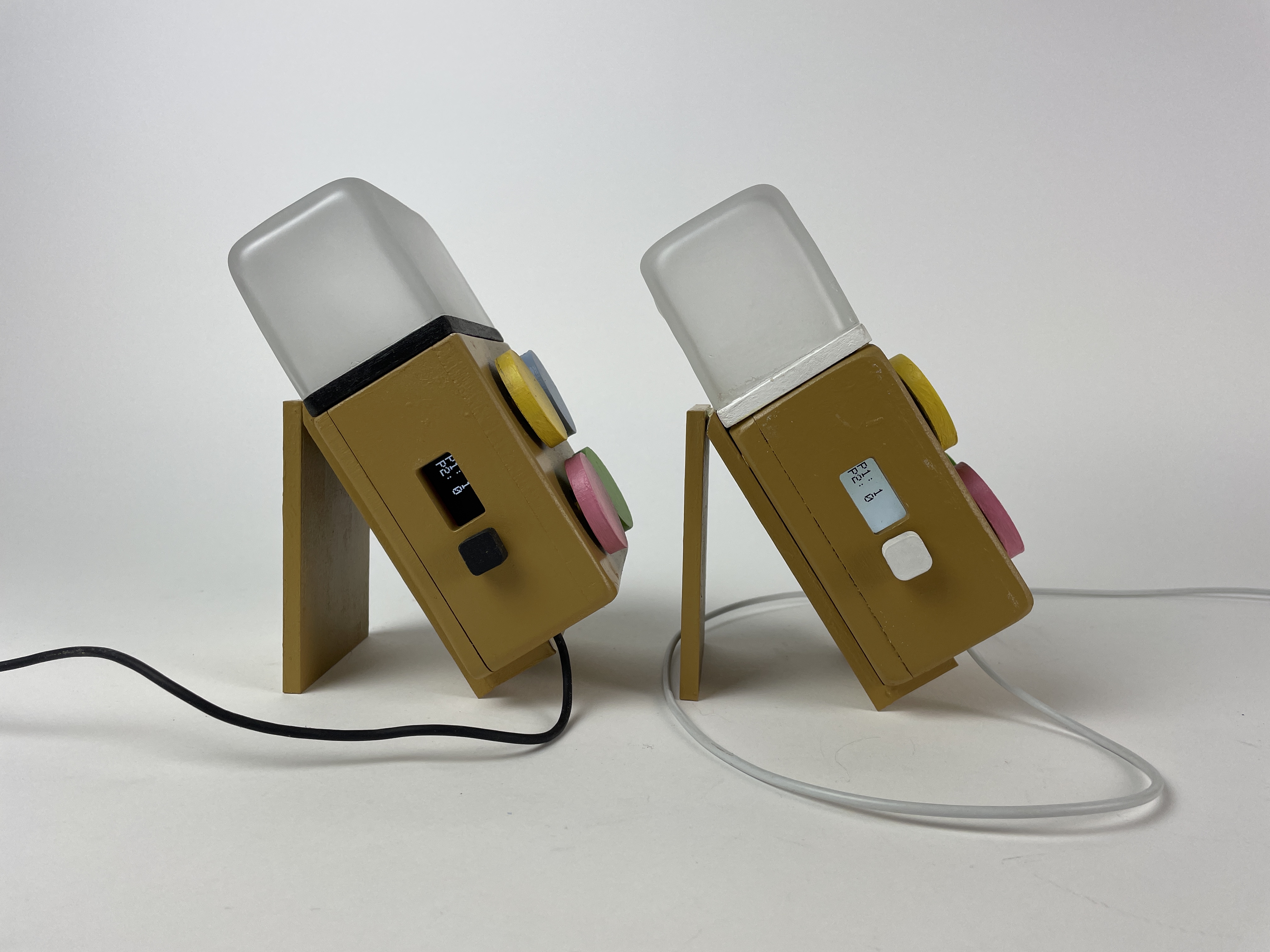 Both Milo units on their stands, side by side on a desk