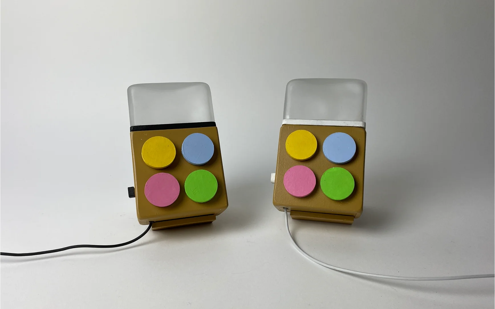 The Milo pair, two small wooden devices with four pastel buttons and a glass-blown diffuser top, sitting side by side