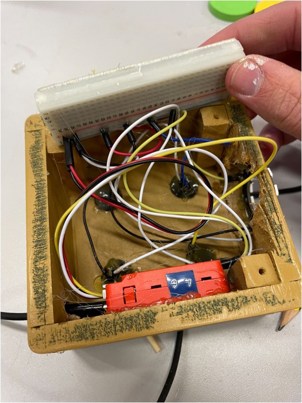 The finished pair being assembled: glass cap joined to MDF connector piece with epoxy, then bonded to the casing