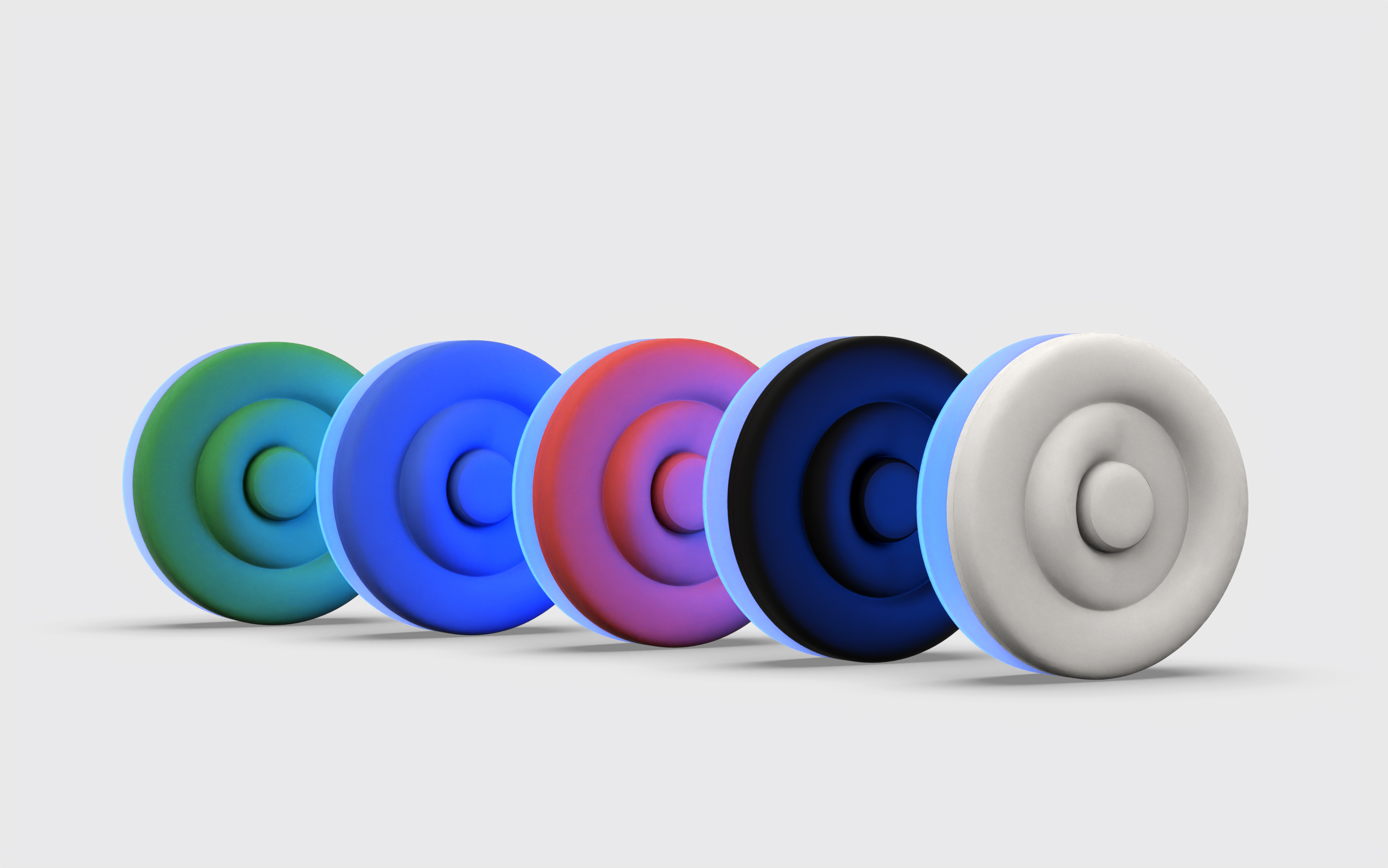 The five colour variants of the Onaka device lined up, green to white, each with a blue glow
