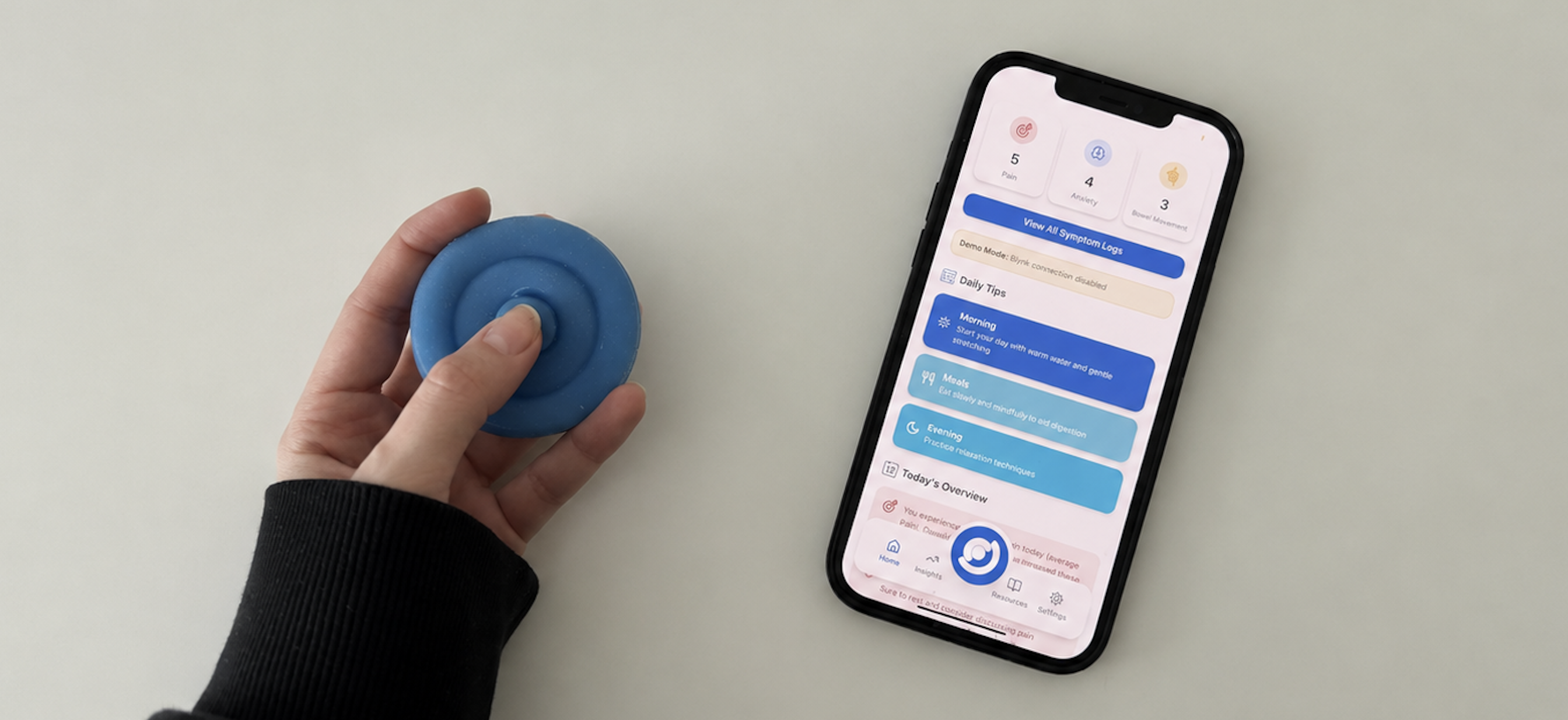 A hand pressing the blue Onaka device beside a phone showing the onaka companion app dashboard with symptom counts and daily tips