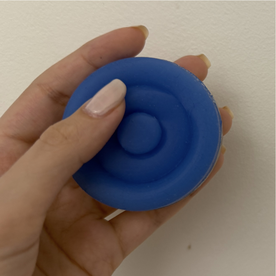 Hand pressing the blue Onaka device