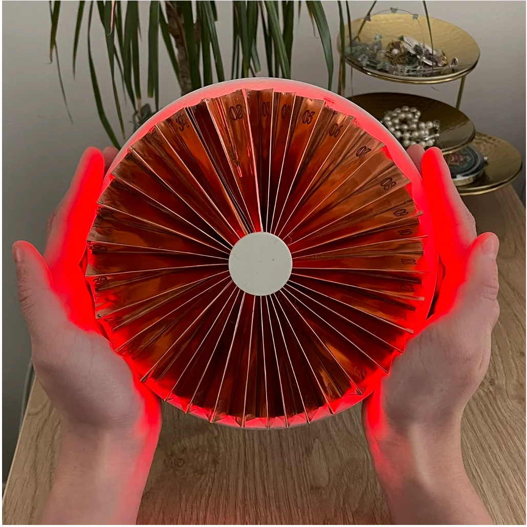 The fan glowing red on a bedside table