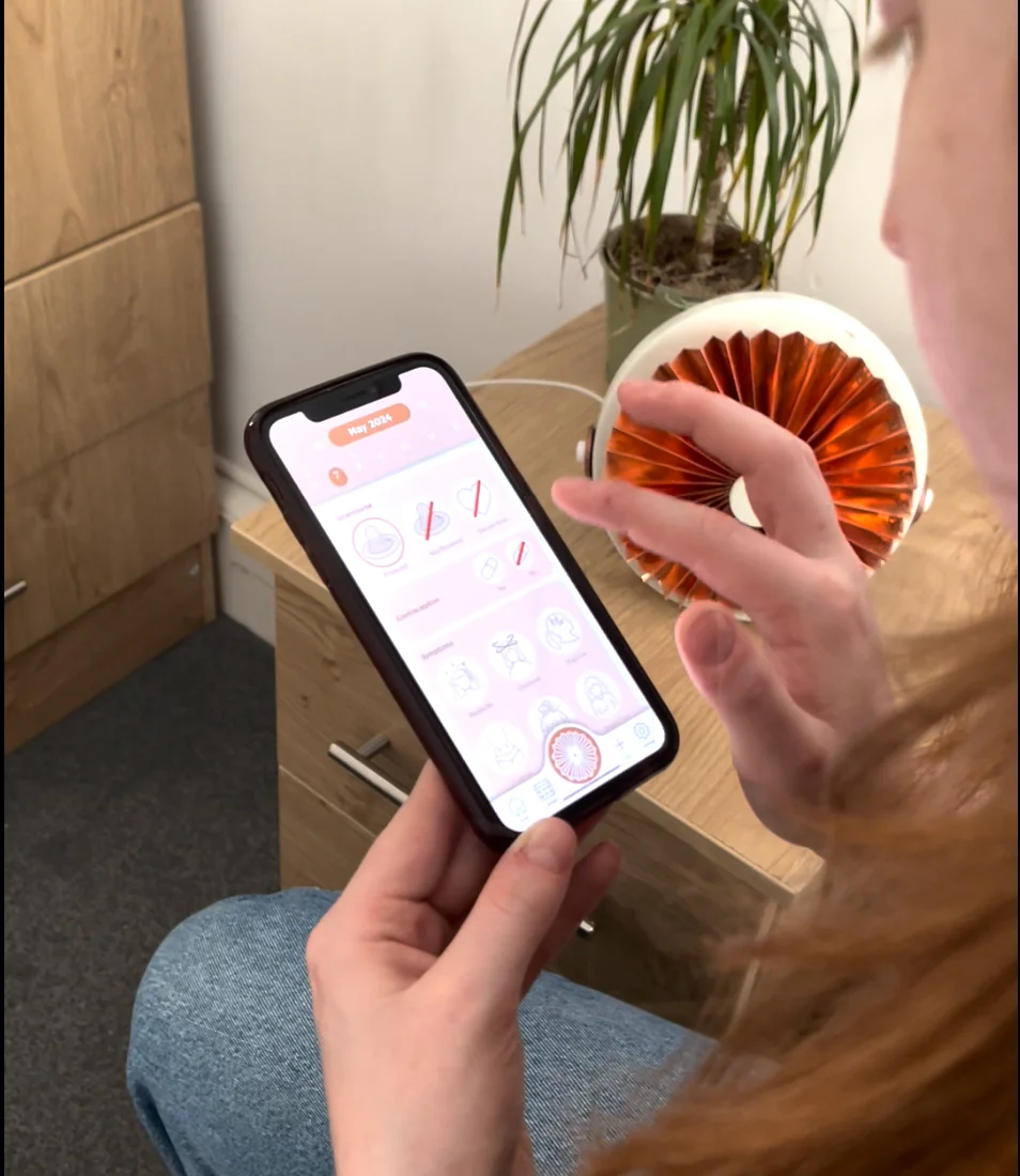Logging symptoms on the phone while reaching for the copper device beside