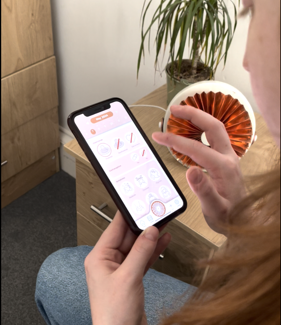 Logging symptoms on the phone while reaching for the copper device beside