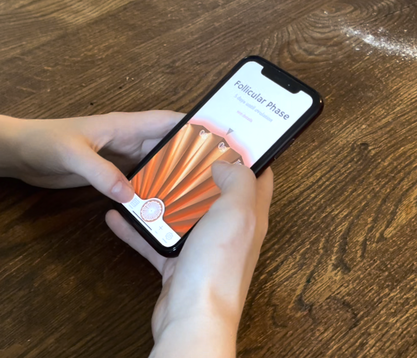 Two hands holding the phone away from the bedside, home screen open